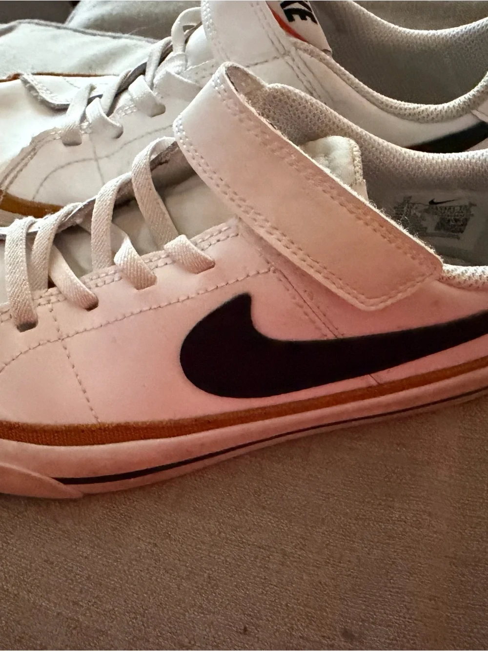 Nike White Sneakers with Black Swoosh and Tan Stripe